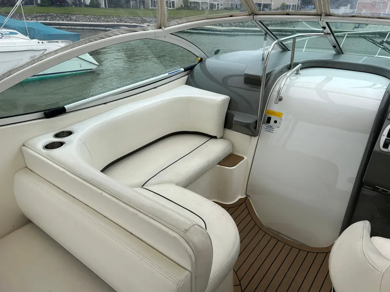 Slide: The Image of 2006 Cruisers Yachts 300 Express interior with white seating and wooden flooring. - 30