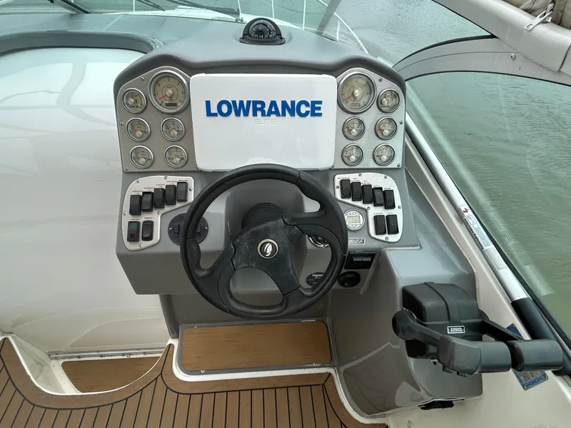 Slide: The Image of 2006 Cruisers Yachts 300 Express helm with Lowrance navigation system and steering wheel. - 31