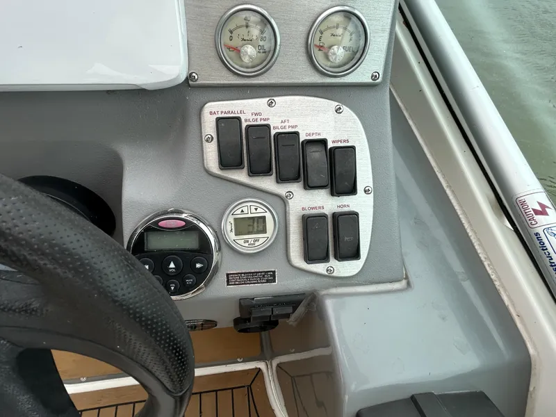 Slide: The Image of Control panel of a 2006 Cruisers Yachts 300 Express boat with gauges and switches. - 36