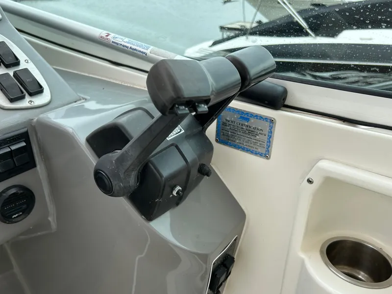 Slide: The Image of Throttle controls on a 2006 Cruisers Yachts 300 Express boat dashboard. - 38