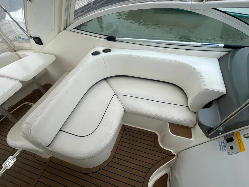 Slide: The Image of 2006 Cruisers Yachts 300 Express interior with white seating and wooden flooring. - 40