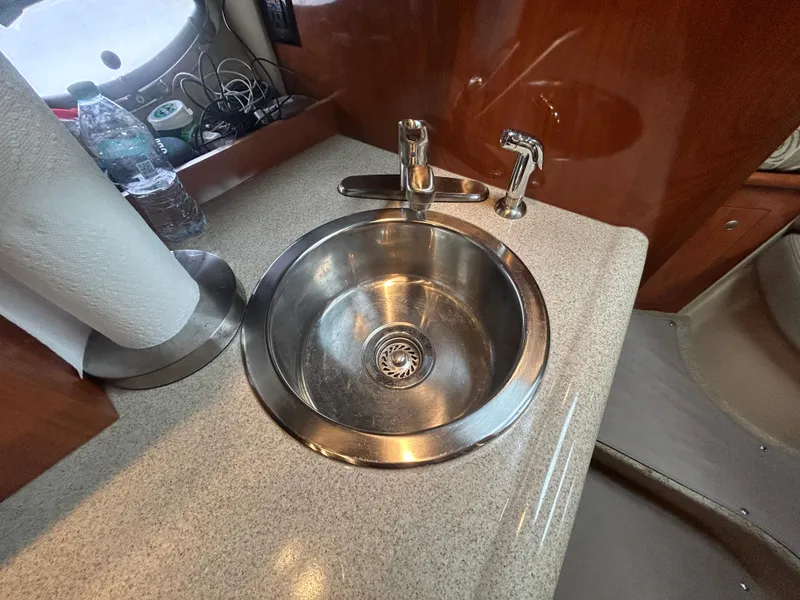 Slide: The Image of 2006 Cruisers Yachts 300 Express kitchen sink with faucet and countertop. - 48
