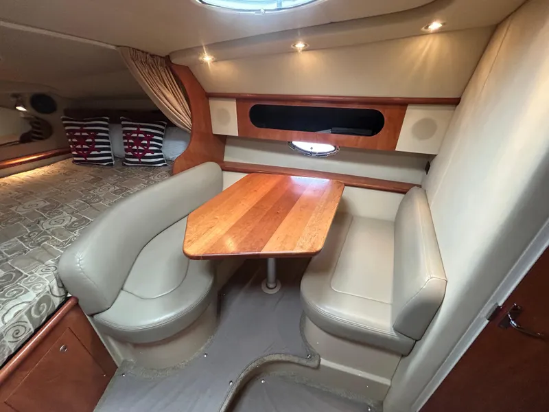 Slide: The Image of 2006 Cruisers Yachts 300 Express interior with dining area and cozy seating. - 49