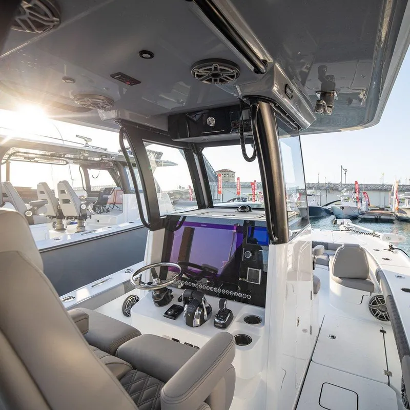 Slide: The Image of 2024 Freeman 28 boat interior with modern helm, docked at marina. - 7