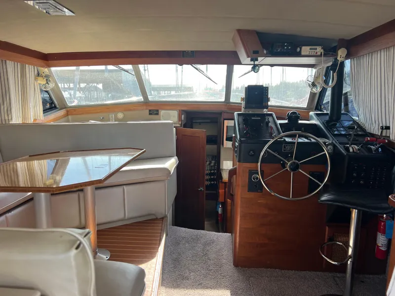 Slide: The Image of 1986 Bayliner 3870 Motoryacht interior with helm, sink, and wooden cabinetry. - 10