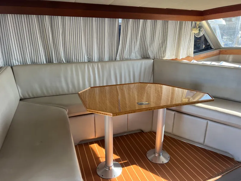 Slide: The Image of 1986 Bayliner 3870 Motoryacht interior with helm, seating, and kitchenette. - 15