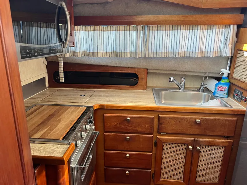 Slide: The Image of Interior of 1986 Bayliner 3870 Motoryacht with wood table and cushioned seating. - 16