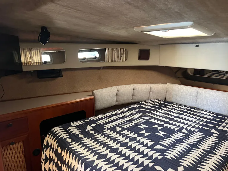 Slide: The Image of 1986 Bayliner 3870 Motoryacht kitchen with stove, sink, and wooden cabinetry. - 17