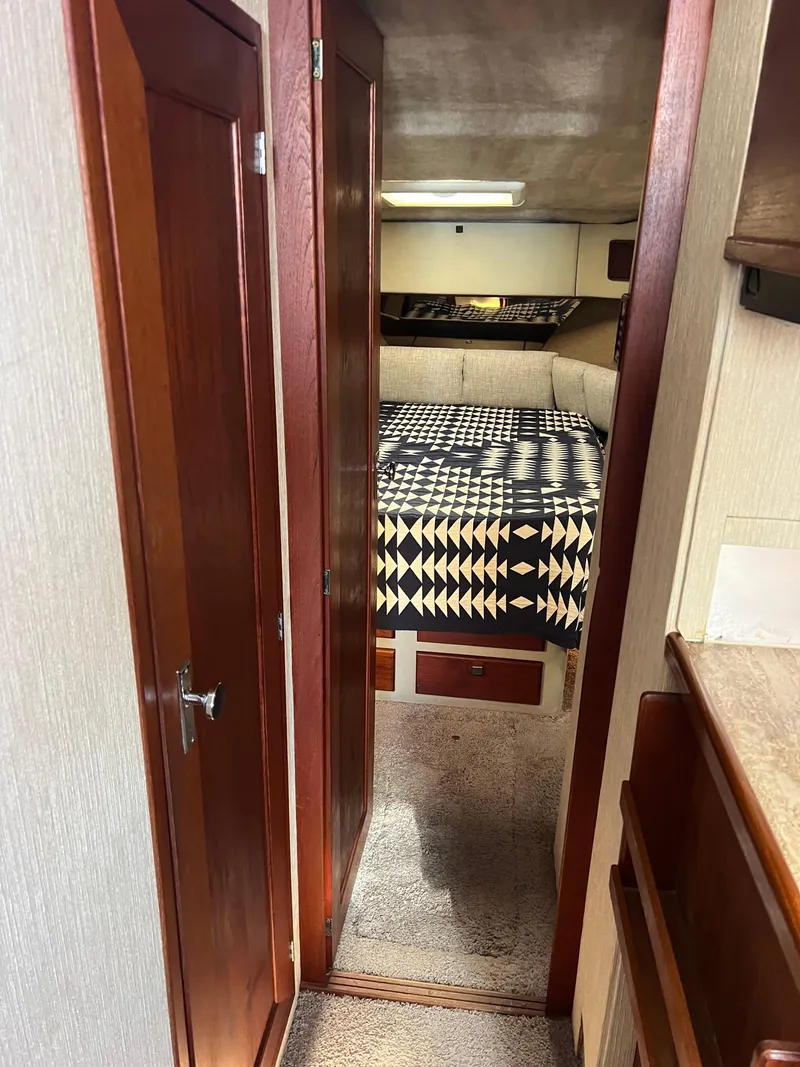 Slide: The Image of 1986 Bayliner 3870 Motoryacht interior cabin with patterned bedding and cozy seating. - 18