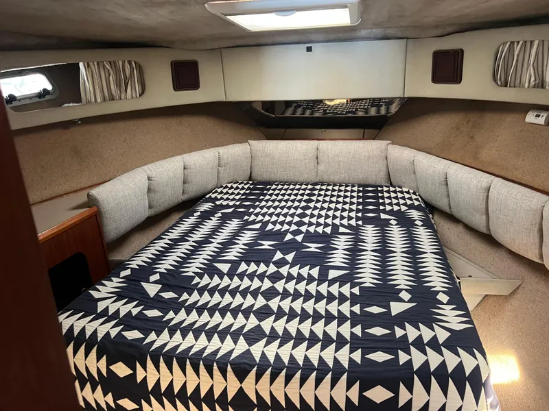 Slide: The Image of 1986 Bayliner 3870 Motoryacht interior with wood paneling and patterned bedspread. - 19