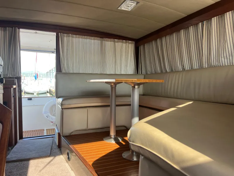 Slide: The Image of Interior of 1986 Bayliner 3870 Motoryacht with wood cabinetry and seating area. - 21