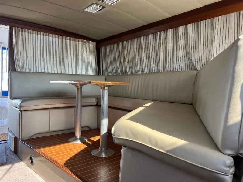 Slide: The Image of 1986 Bayliner 3870 Motoryacht interior with patterned bedding and mounted TV. - 25