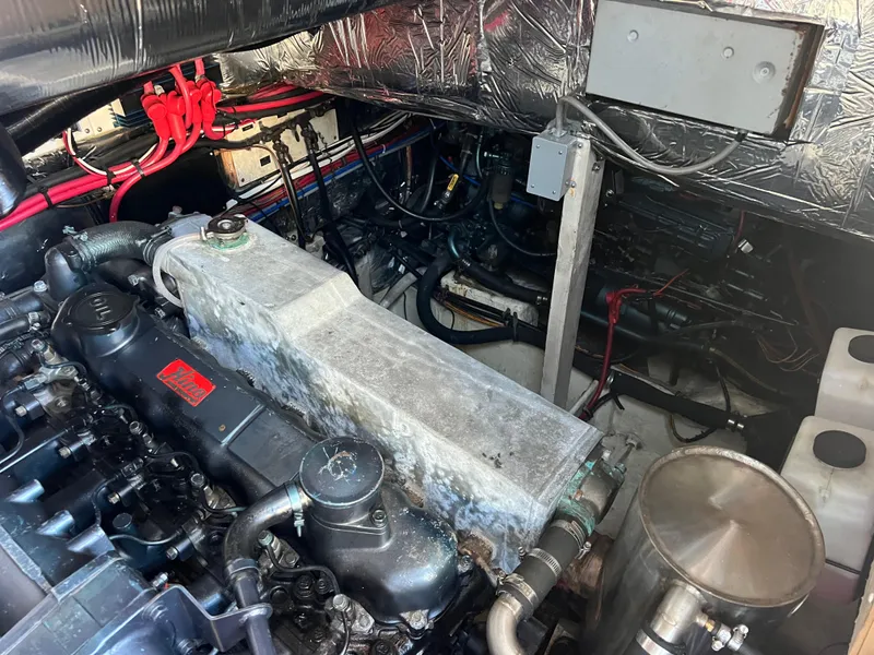 Slide: The Image of 1986 Bayliner 3870 Motoryacht kitchen with wood cabinetry, sink, and mini fridge. - 31