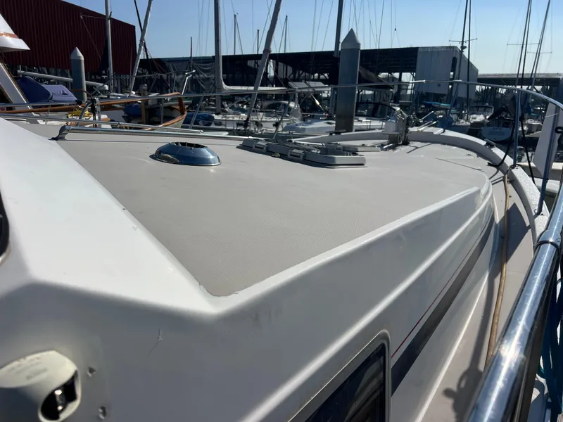 Slide: The Image of 1986 Bayliner 3870 Motoryacht with blue canopy, docked under clear sky. - 43
