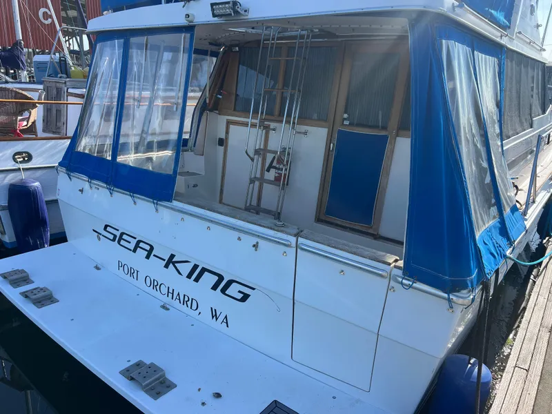 Slide: The Image of 1986 Bayliner 3870 Motoryacht helm with steering wheel, controls, and cushioned seating. - 8