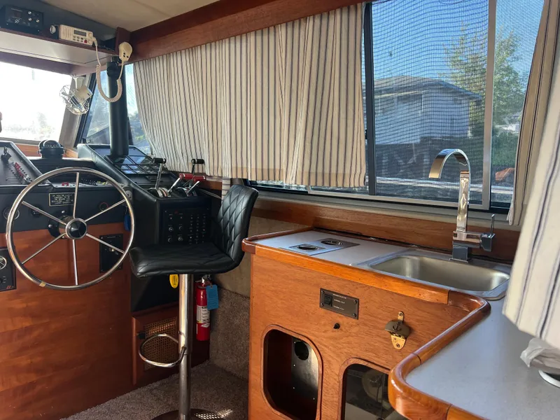 Slide: The Image of 1986 Bayliner 3870 Motoryacht docked, featuring blue trim and "Sea-King" name at Port Orchard, WA. - 9