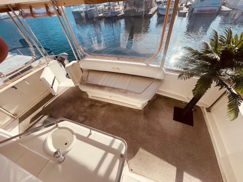 Slide: The Image of 1998 Sea Ray 370 Aft Cabin helm with white seating and panoramic windows. - 12