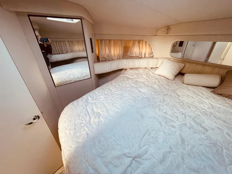 Slide: The Image of Cozy bedroom in 1998 Sea Ray 370 Aft Cabin yacht with plush bedding and mirrored closet. - 16