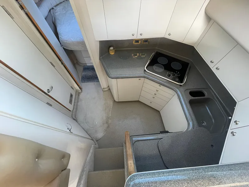 Slide: The Image of 1998 Sea Ray 370 Aft Cabin bedroom with cozy bedding and mirrored wall. - 17
