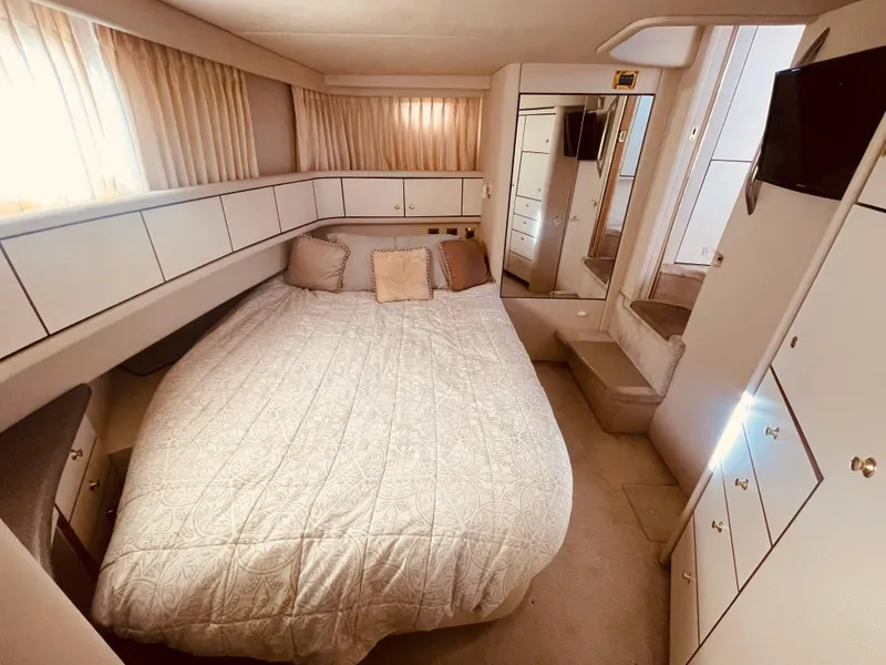 Slide: The Image of 1998 Sea Ray 370 Aft Cabin interior with washer and bathroom. - 23
