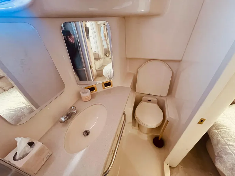 Slide: The Image of 1998 Sea Ray 370 Aft Cabin yacht docked, featuring sleek design and contact number displayed. - 27