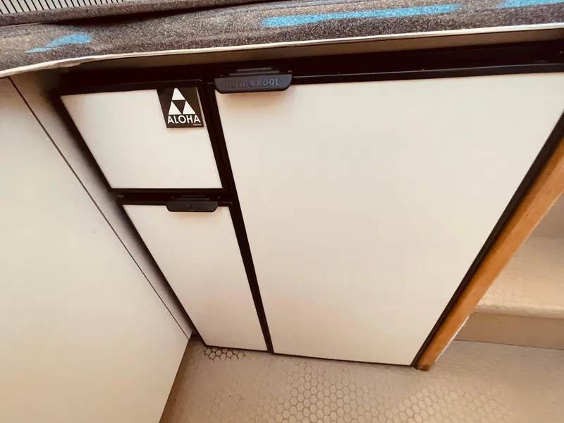 Slide: The Image of 1998 Sea Ray 370 Aft Cabin boat interior with seating and helm, docked in marina. - 30