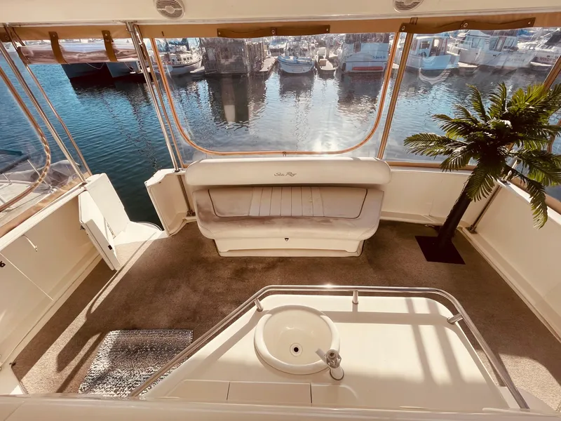 Slide: The Image of 1998 Sea Ray 370 Aft Cabin interior with plush seating and panoramic windows. - 8