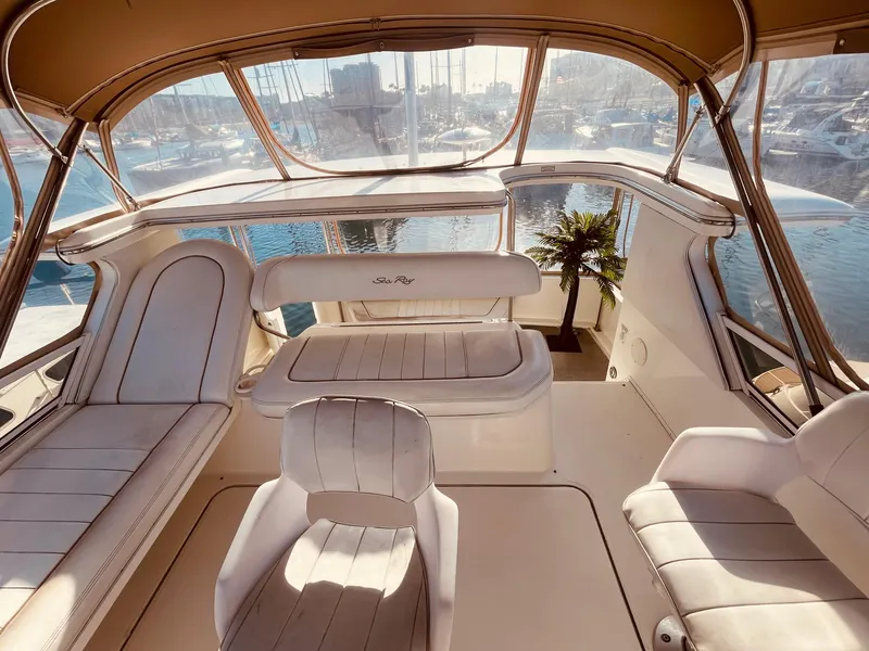 Slide: The Image of 1998 Sea Ray 370 Aft Cabin helm with seating, overlooking marina. - 9