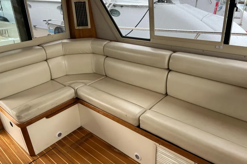 Slide: The Image of 2004 Albin 35 Tournament Express interior with beige leather seating and wooden flooring. - 17