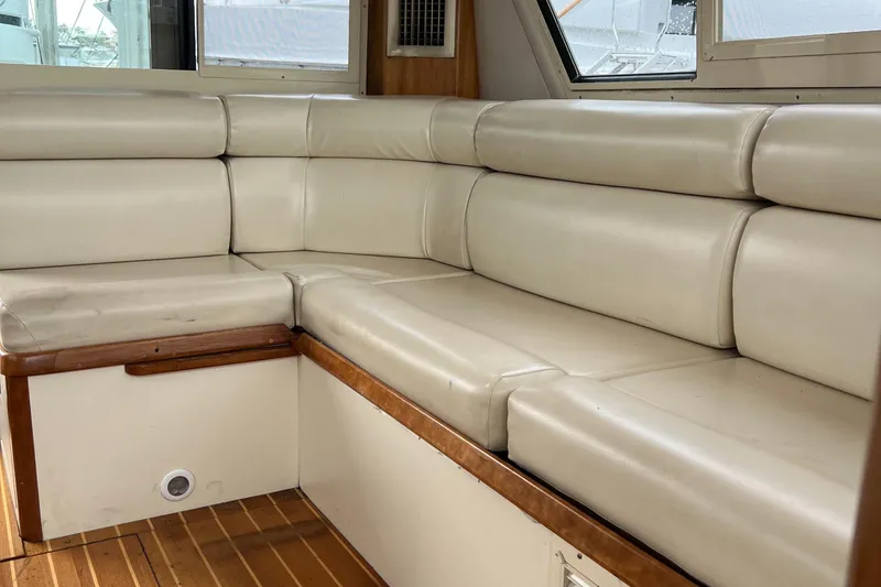 Slide: The Image of 2004 Albin 35 Tournament Express interior with beige leather seating and wooden flooring. - 18
