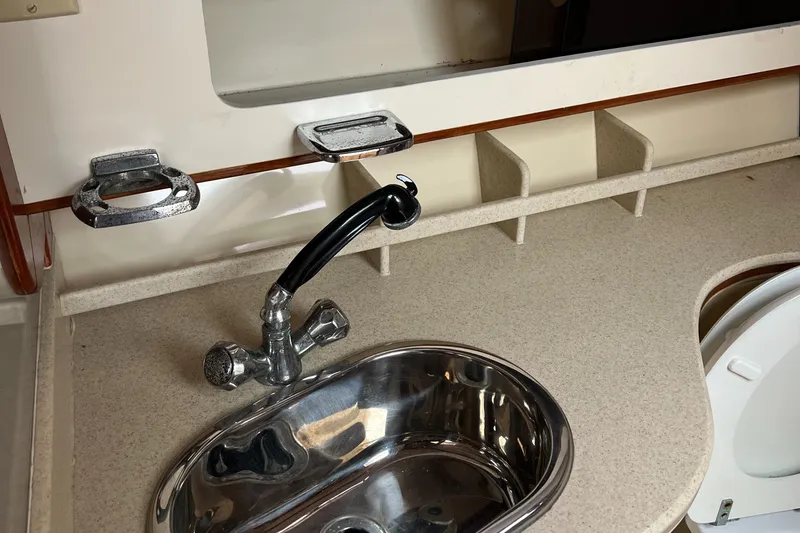 Slide: The Image of 2004 Albin 35 Tournament Express boat interior with sink and faucet. - 23