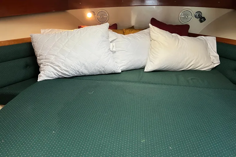 Slide: The Image of Cozy cabin interior of 2004 Albin 35 Tournament Express with green bedding and pillows. - 26