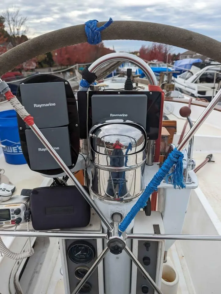 Slide: The Image of 1985 Endeavour 42 CC sailboat helm with Raymarine navigation equipment and stainless steel wheel. - 2