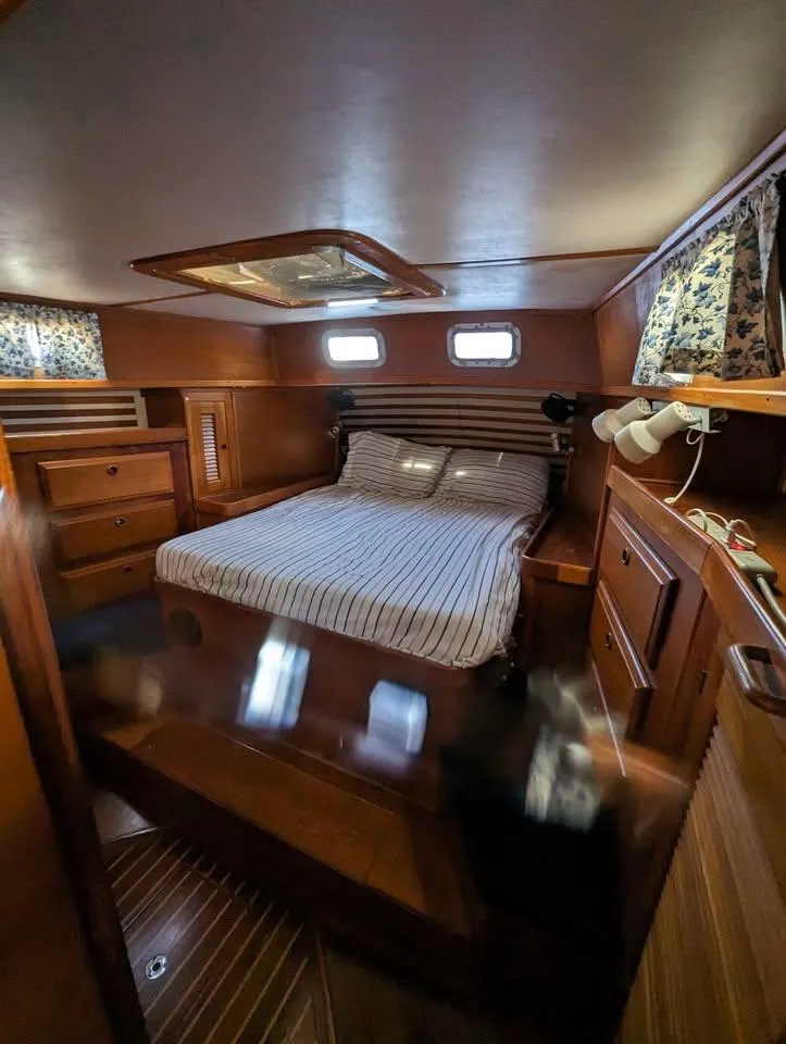 Slide: The Image of Cozy cabin interior of 1985 Endeavour 42 CC sailboat with double bed and wooden furnishings. - 4