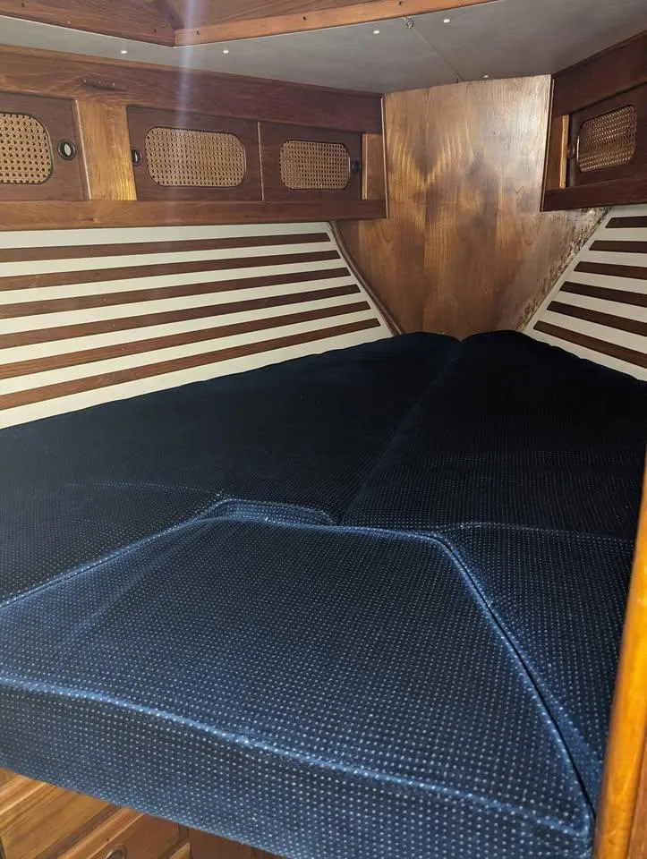 Slide: The Image of Cozy cabin interior of 1985 Endeavour 42 CC sailboat with blue cushions. - 8