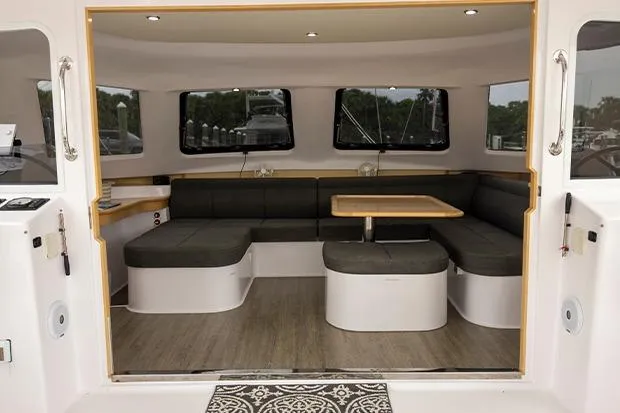 Slide: The Image of Interior of 2019 Seawind 1260 catamaran with modern seating and dining area. - 11