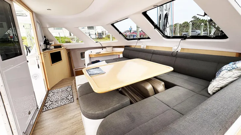 Slide: The Image of Interior of 2019 Seawind 1260 catamaran with modern seating and dining area. - 12