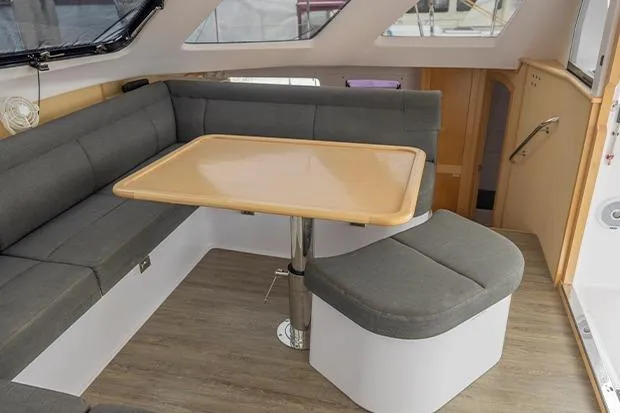 Slide: The Image of Interior of 2019 Seawind 1260 catamaran with modern seating and wooden table. - 14