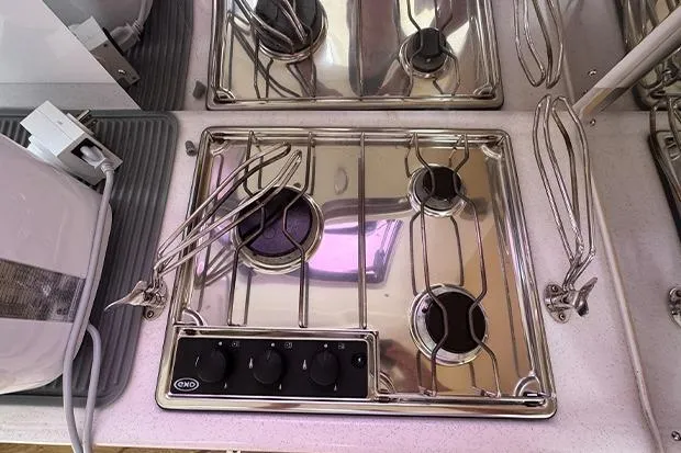 Slide: The Image of Stainless steel stove on 2019 Seawind 1260 catamaran, featuring three burners and control knobs. - 18