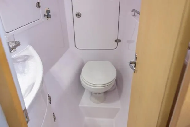Slide: The Image of Compact bathroom in 2019 Seawind 1260 catamaran, featuring toilet and sink. - 23