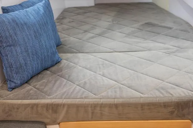 Slide: The Image of Cozy interior of 2019 Seawind 1260 with plush bedding and blue pillow. - 24