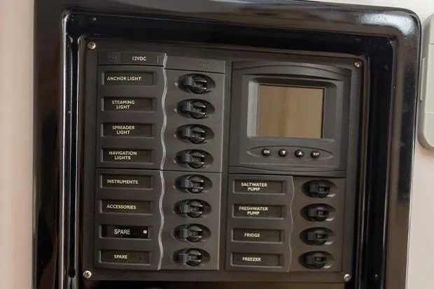 Slide: The Image of Control panel of a 2019 Seawind 1260 catamaran with labeled switches and display. - 25