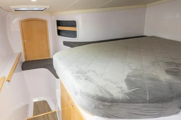 Slide: The Image of 2019 Seawind 1260 interior cabin with bed, wooden door, and modern design. - 28
