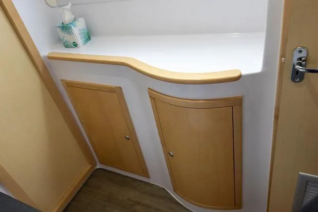 Slide: The Image of Interior of 2019 Seawind 1260 yacht with wooden cabinets and countertop. - 29