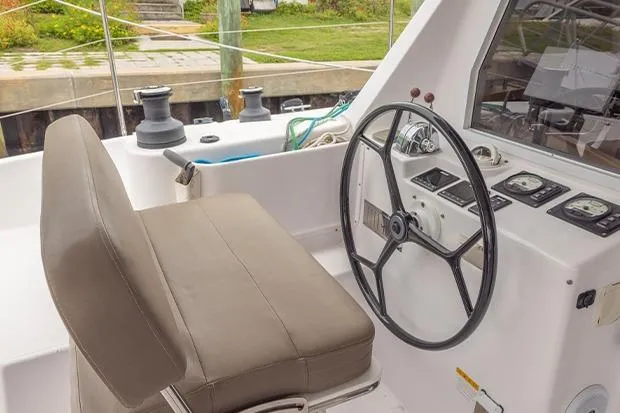 Slide: The Image of 2019 Seawind 1260 catamaran helm with steering wheel and navigation controls. - 5
