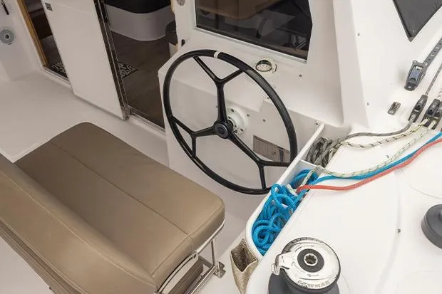 Slide: The Image of 2019 Seawind 1260 yacht cockpit with steering wheel and ropes. - 9