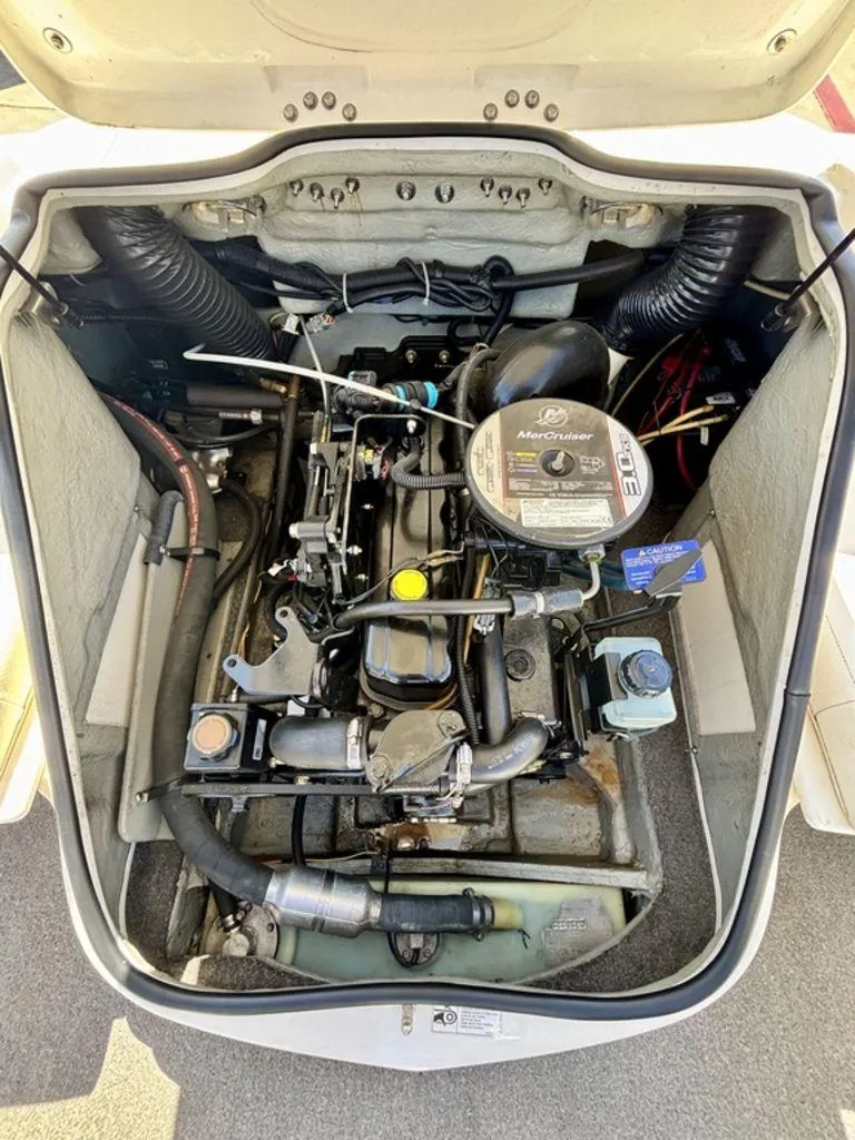Slide: The Image of Engine compartment of a 2012 Bayliner 185 Bowrider, featuring a MerCruiser engine. - 8