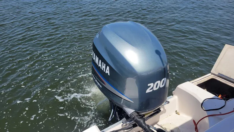 Slide: The Image of Yamaha 200 Four Stroke engine on 2003 Hurricane 237 Fun Deck boat in water. - 10