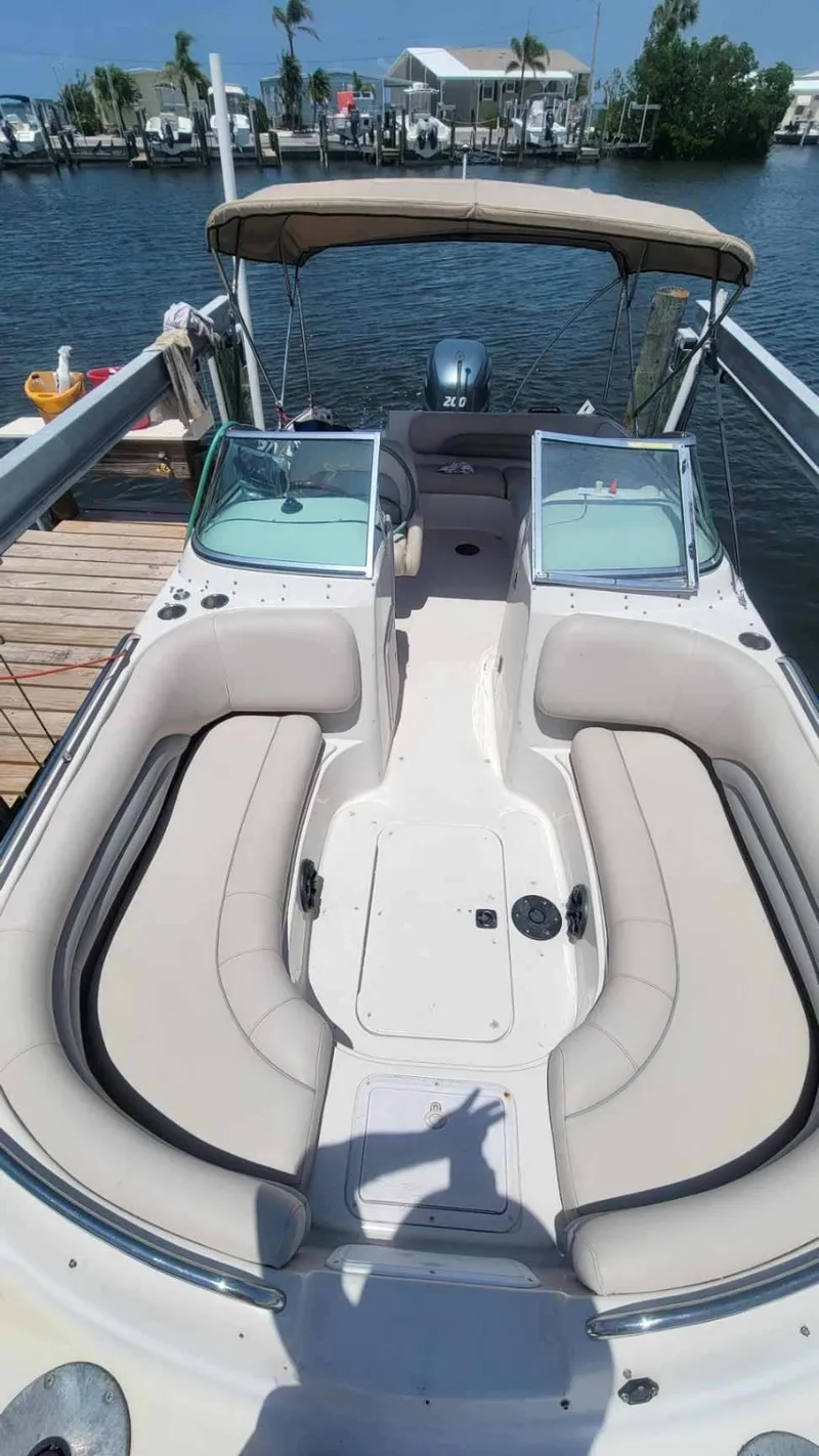 Slide: The Image of 2003 Hurricane 237 Fun Deck boat with Yamaha 200 Four Stroke, docked by the water. - 11