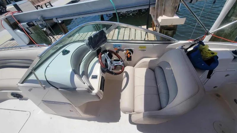 Slide: The Image of 2003 Hurricane 237 Fun Deck boat interior with Yamaha 200 Four Stroke engine, docked by water. - 12
